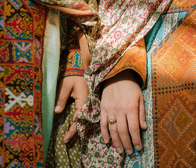 Two Baluchi women hands next to each other
