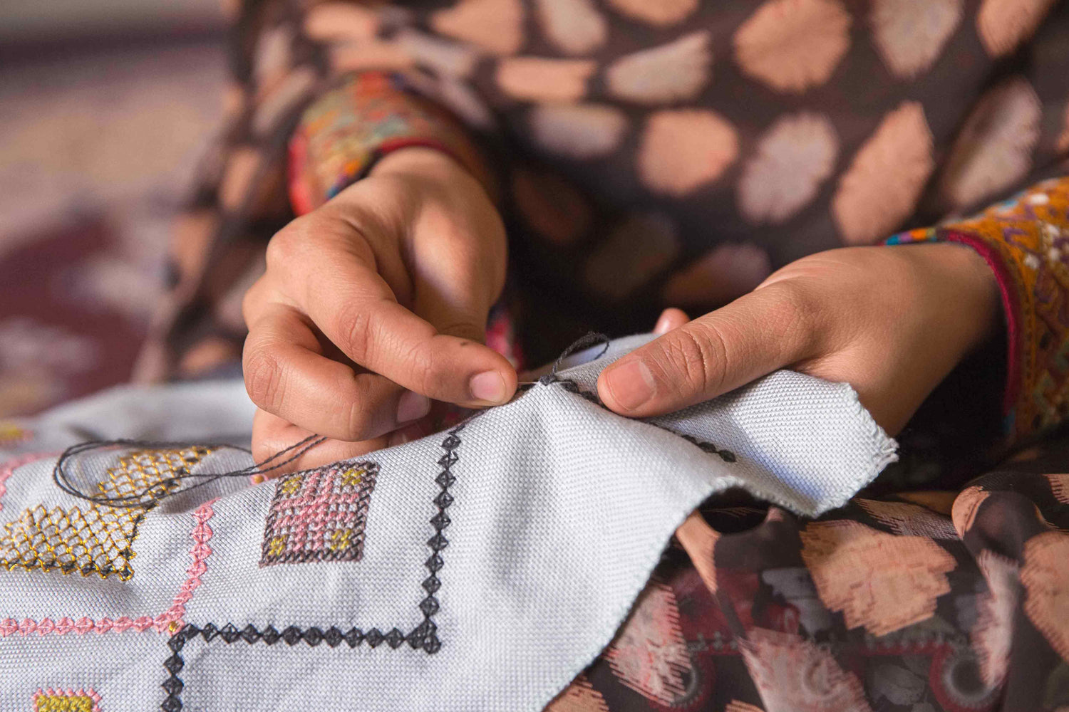 Baluchi woman embroidering a cushion