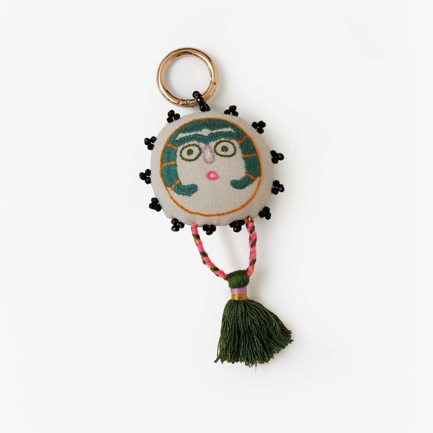 Turquoise Sun Lady charm with embroidery and a braided tassel