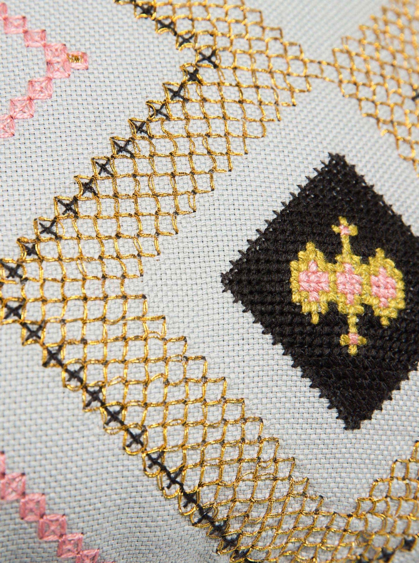 Close up detail of Silvergray / Gold Gouder cushion with Baluchi embroidery