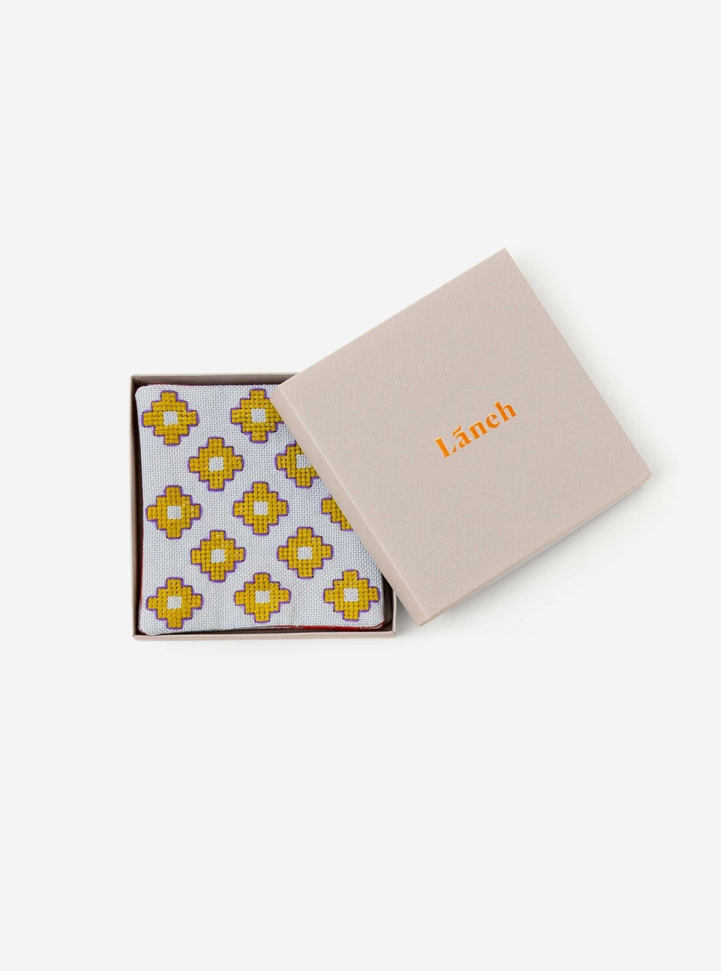 Silver gray Apadana coaster set with green flower embroidery inside a light grey Laneh box