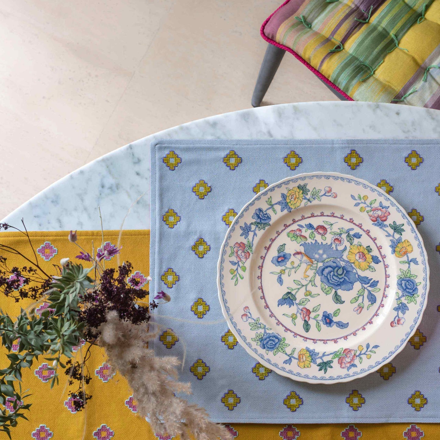 Apadana silver gray placemat and mustard runner on a table