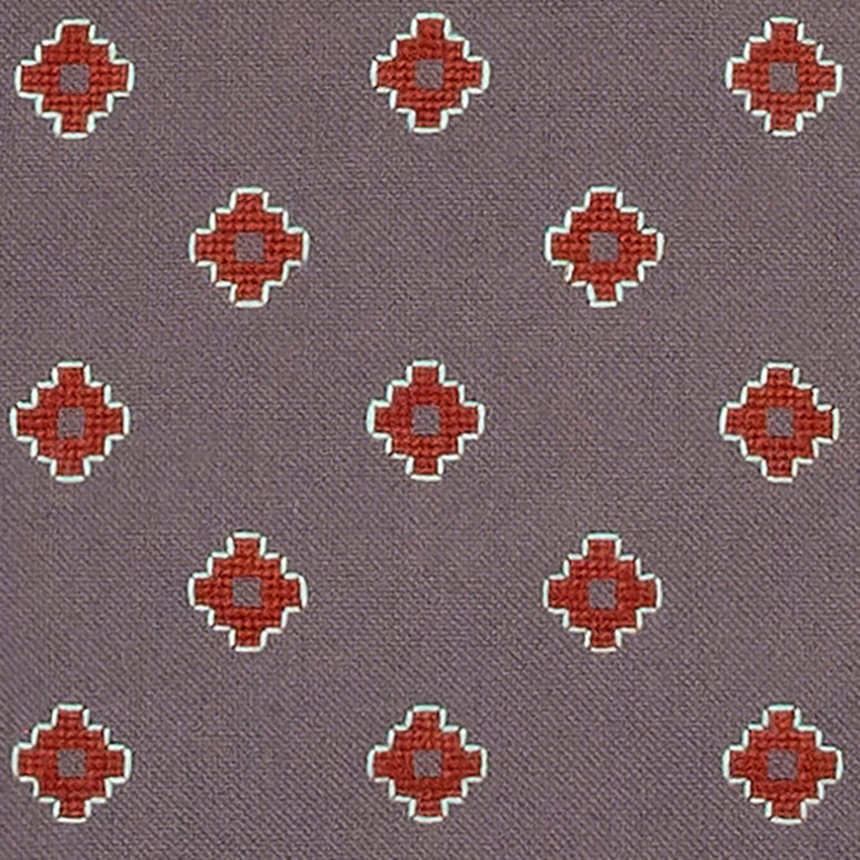 close up detail of dove grey Apadana placemat with dark red flower embroidery
