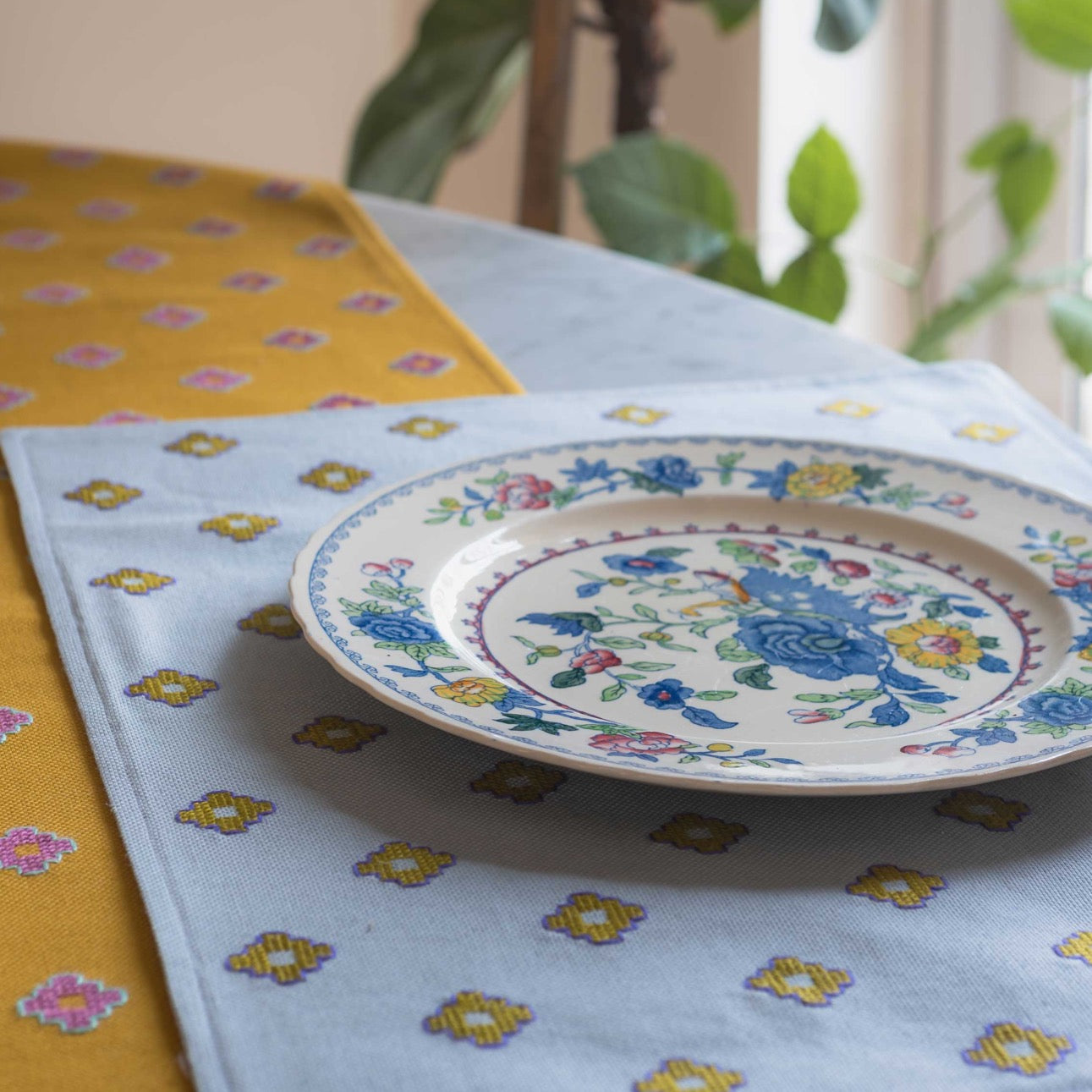 placemat and mustard runner on a table