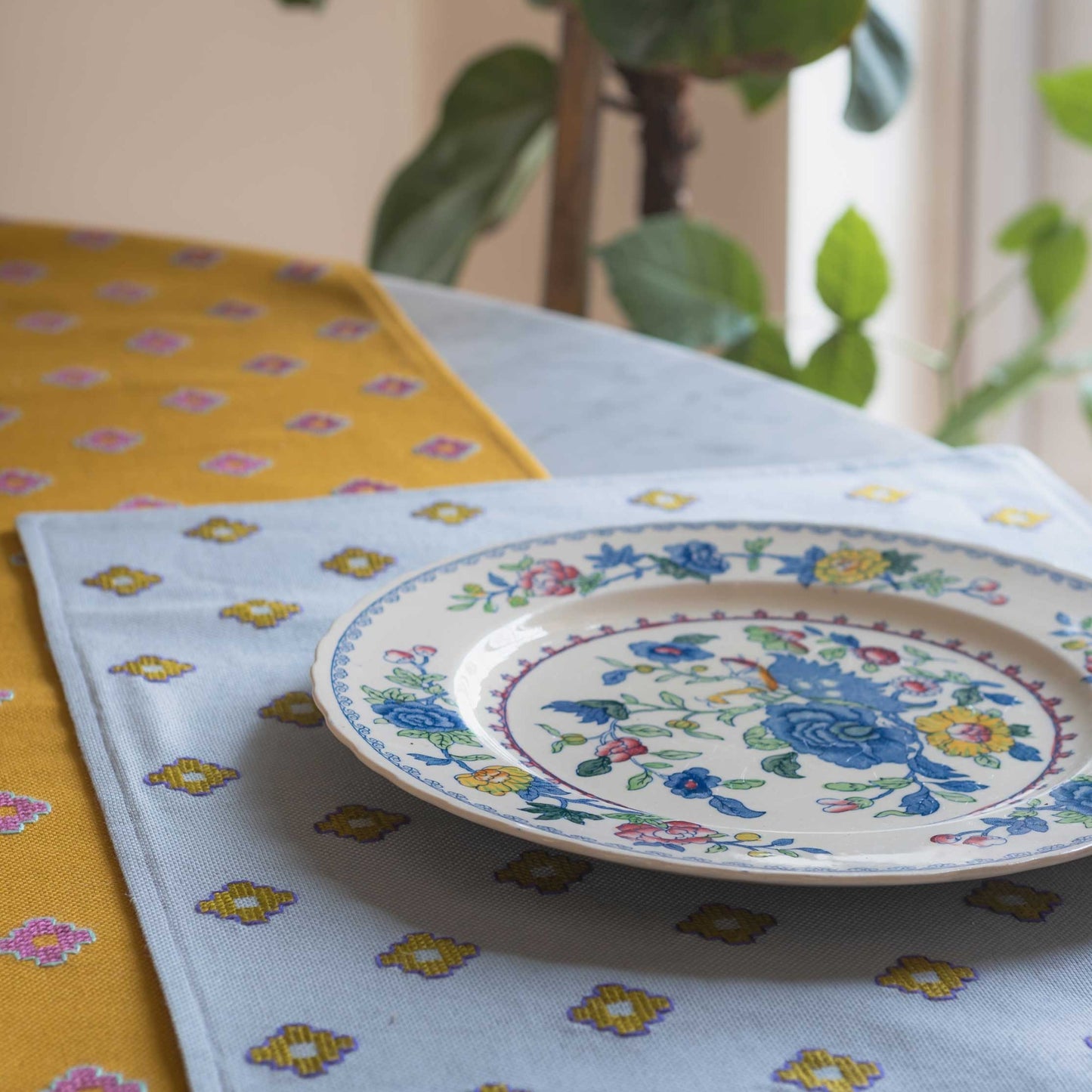 placemat and mustard runner on a table