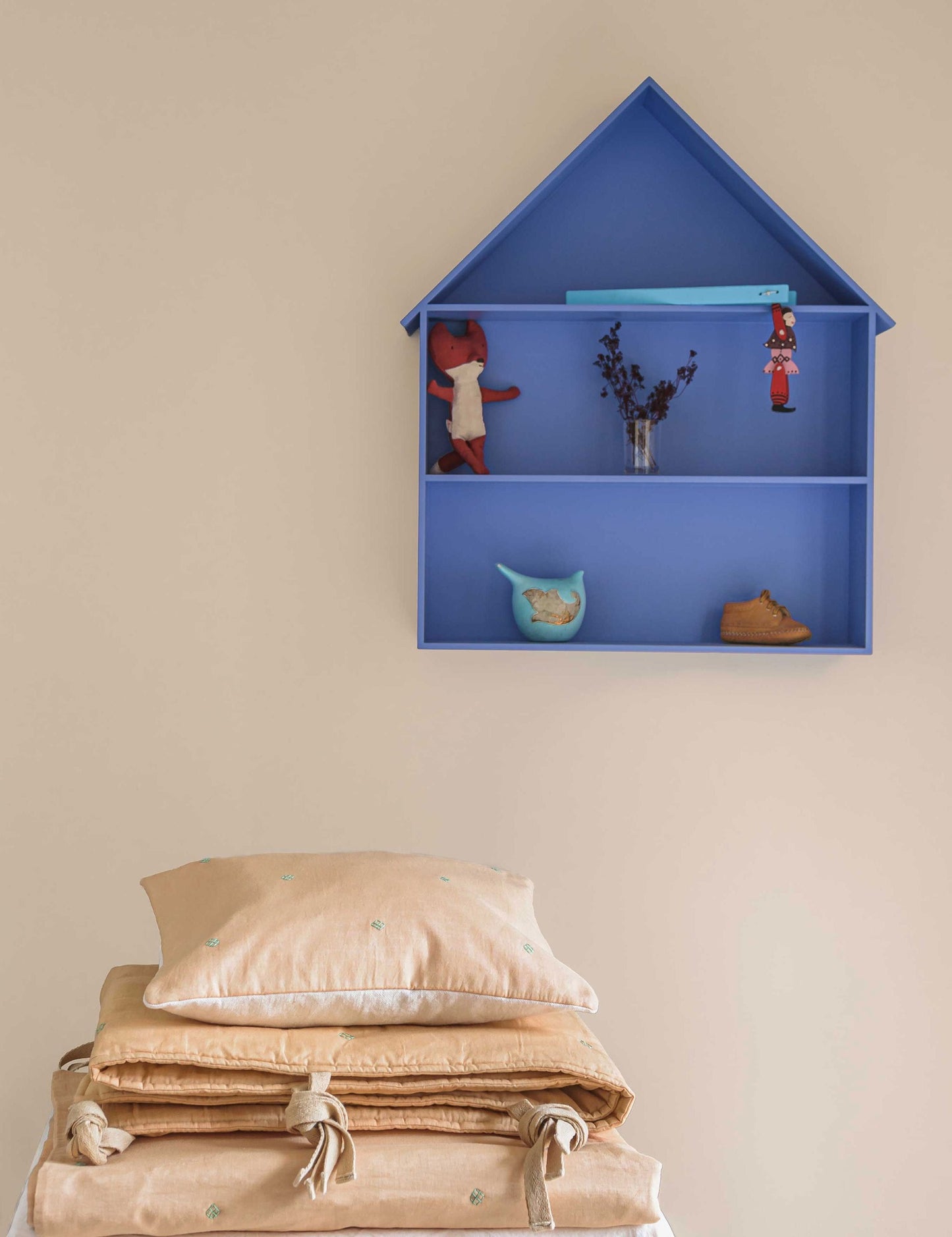 Wheat Bandook pillow, bumper and blanket stacked on top of each other