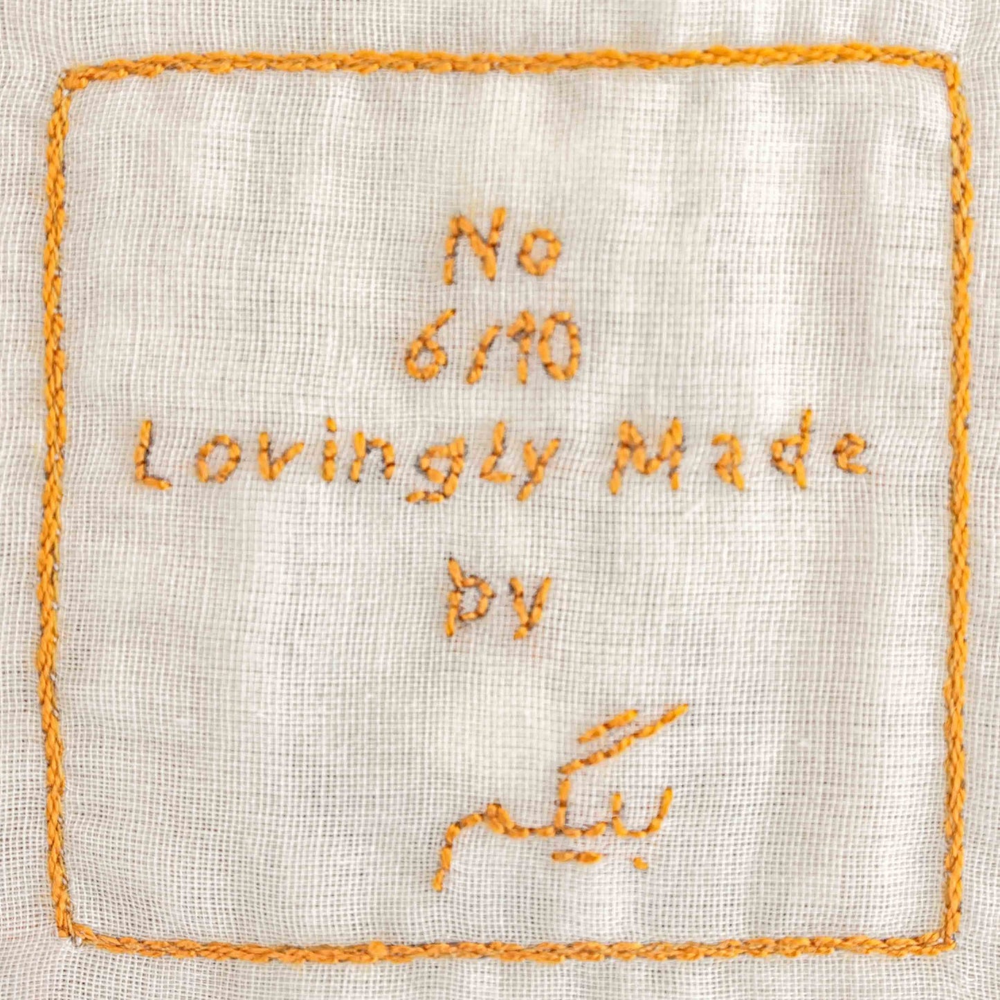 Hand embroidered label with the edition number of the bibi limited editioned cushion