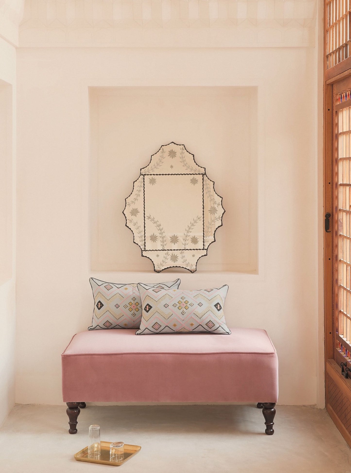 Two Silvergray/ Gold Gouder cushion with embroidery on top og a pink chair in Manouchehri House in Kashan