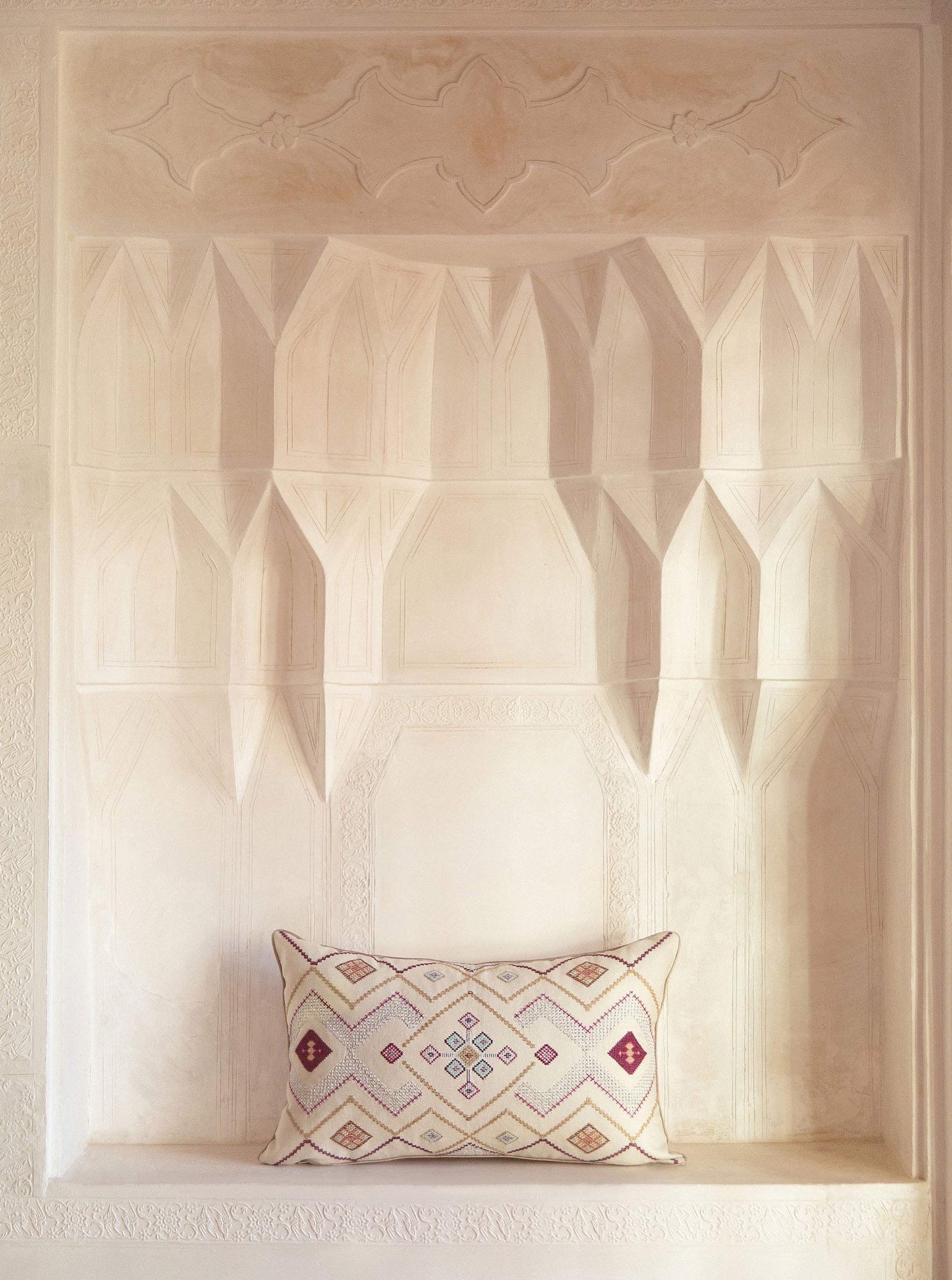 Ivory/ Silver Gouder cushion with embroidery inside the Manouchehri house in historical city of Kashan
