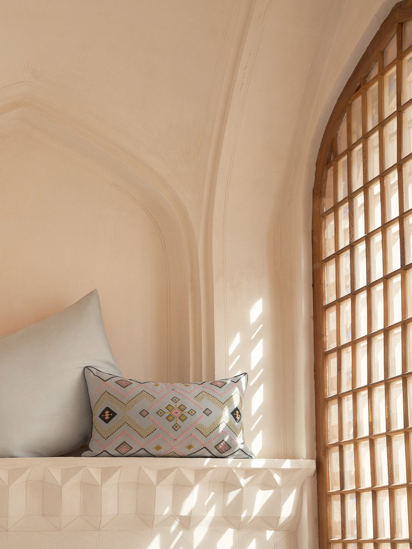 Silver Gray Gouder cushion next to a blue pillow inside the historical Iranian house