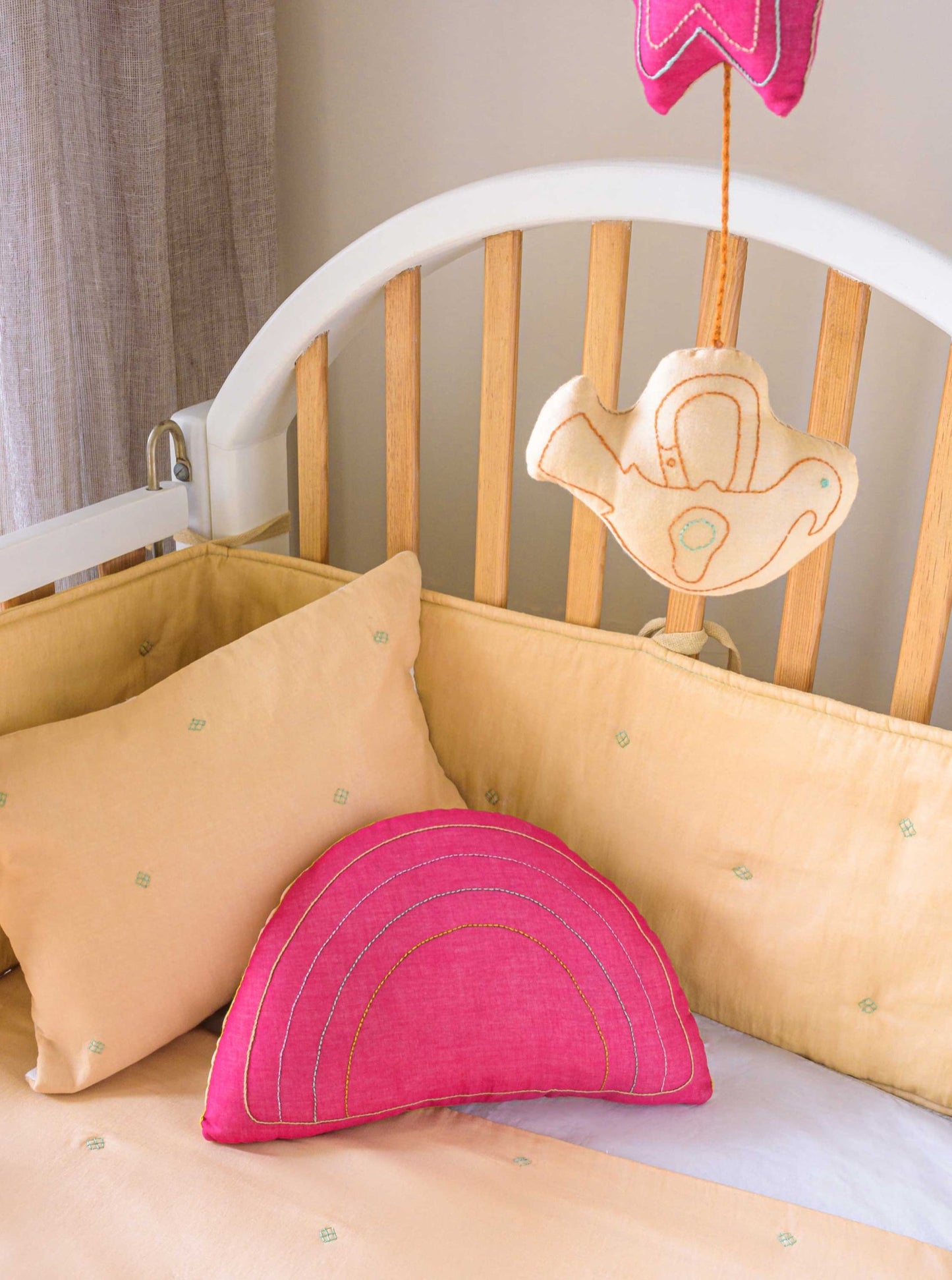Fuchsia Rainbow decorative kids cushion with embroidery next to Bandook baby pillowcase, bumper and blanket