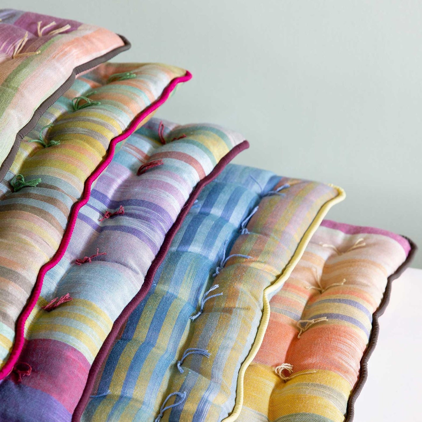 different colors of Royal Road square seat pads stacked on top of each other
