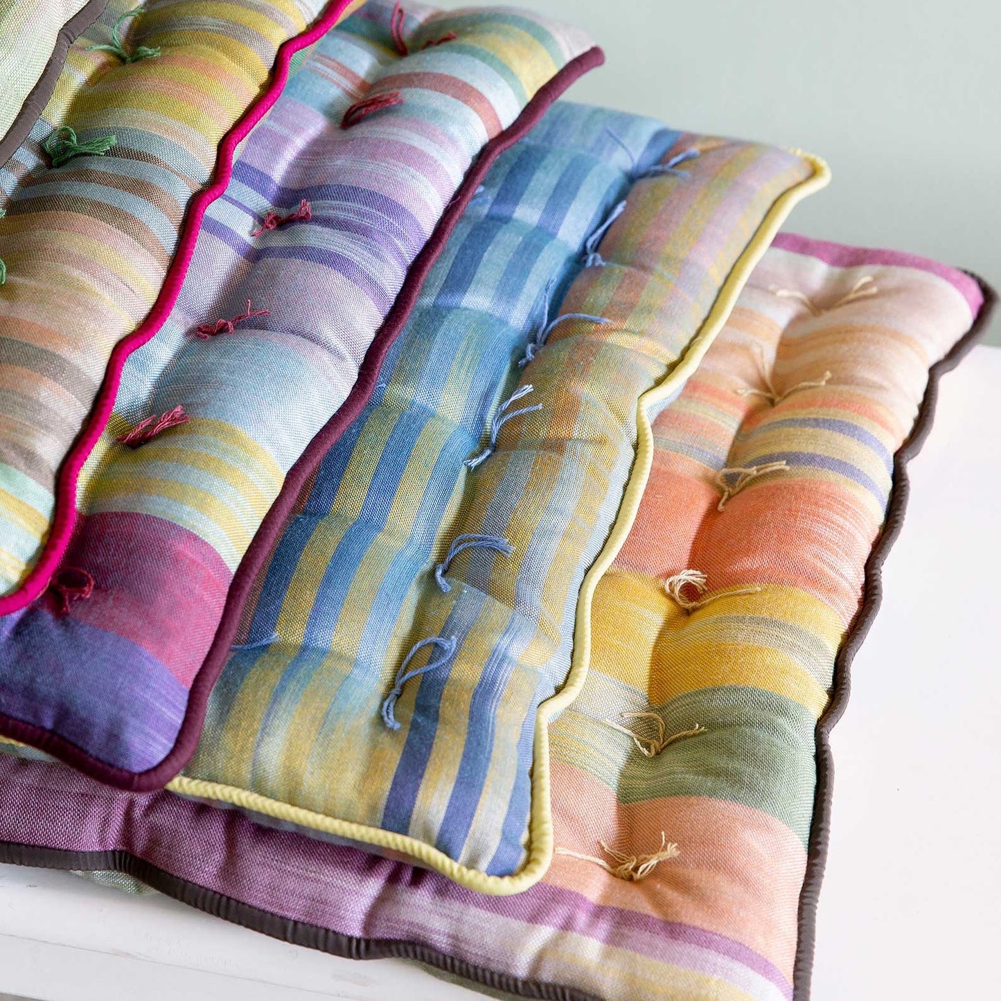 different colors of Royal Road square seat pads stacked on top of each other
