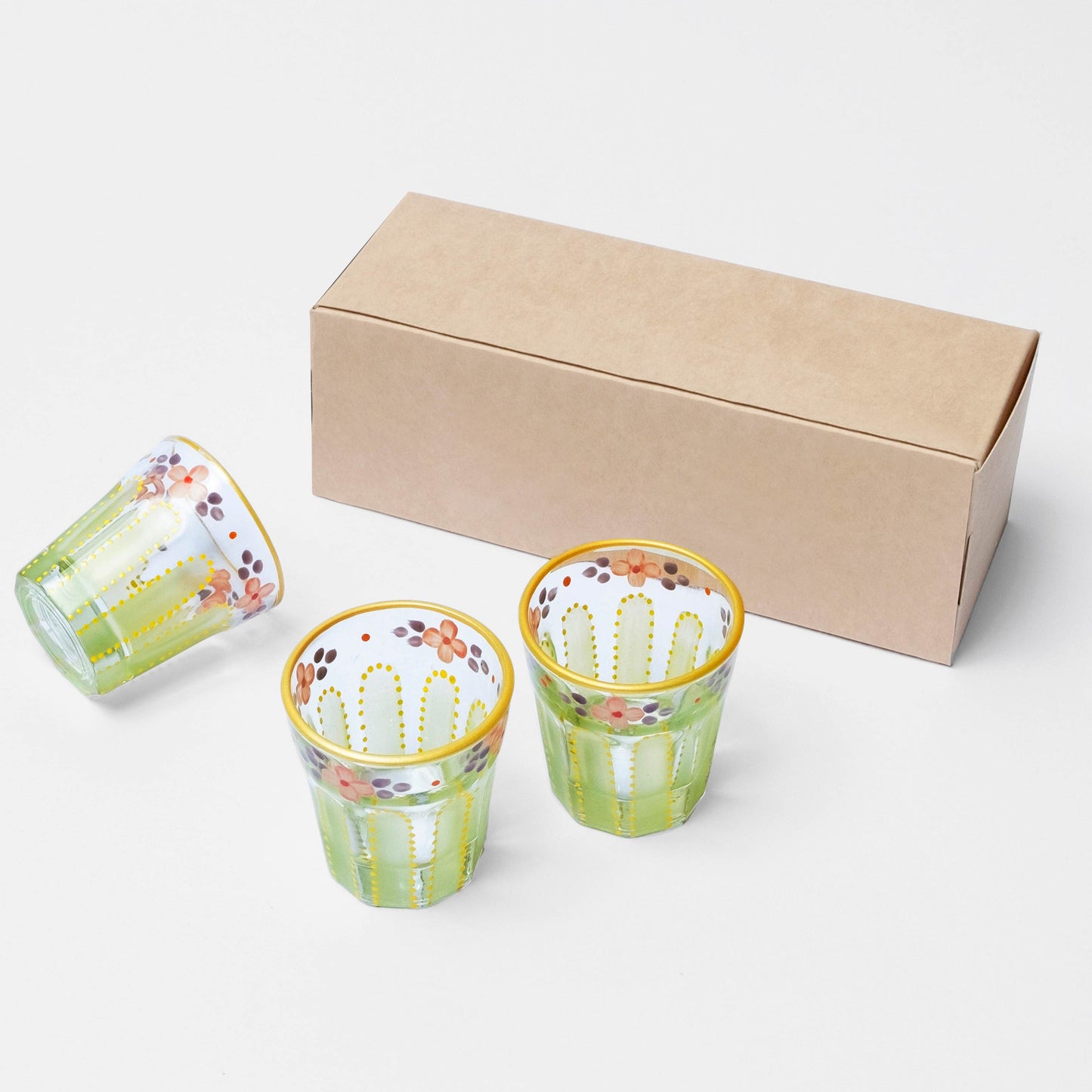 Three Lime Saghi shot glasses next to a kraft packaging box