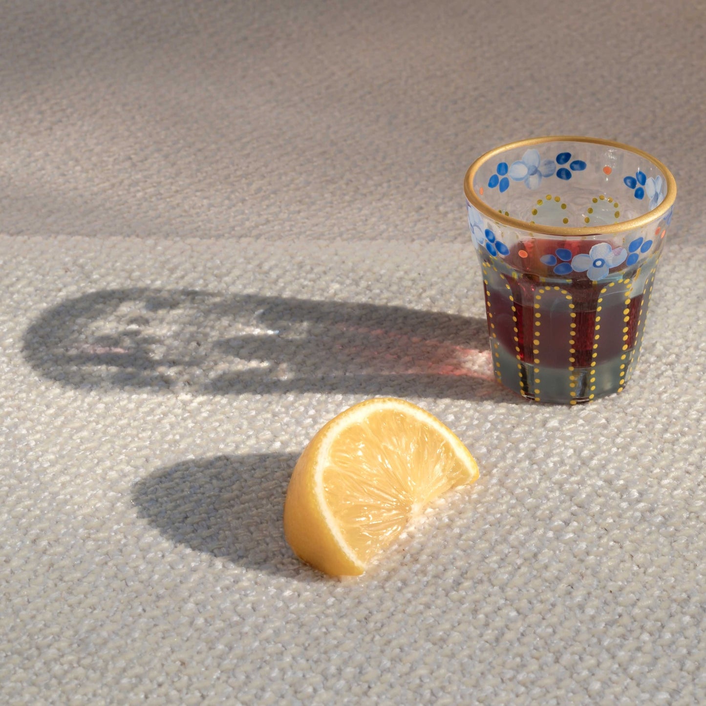 Nile blue Saghi shot glass next to a lemon