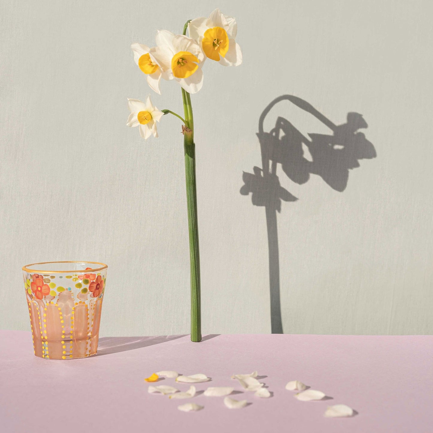 Coral Saghi shot glass placed on a table with a flower