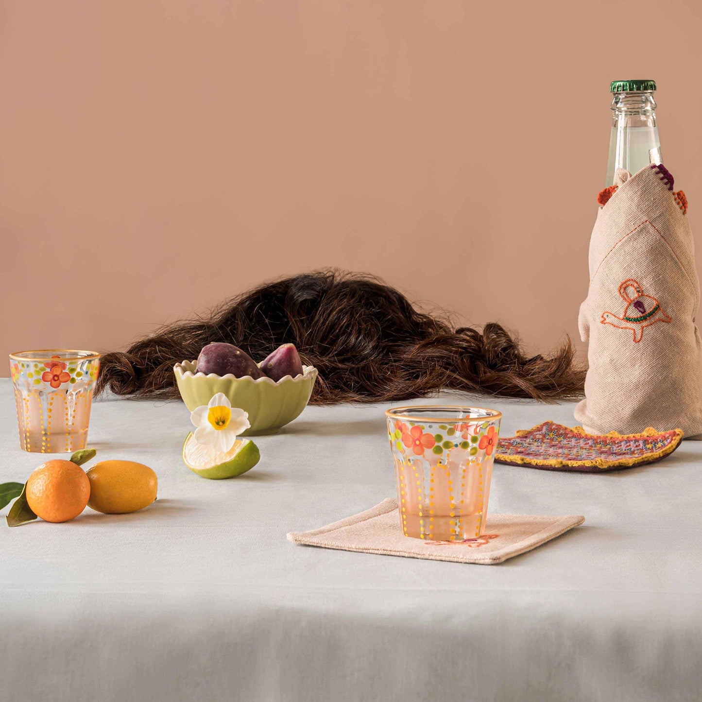 two Coral Saghi shot glasses and Bibi coaster all placed on a table