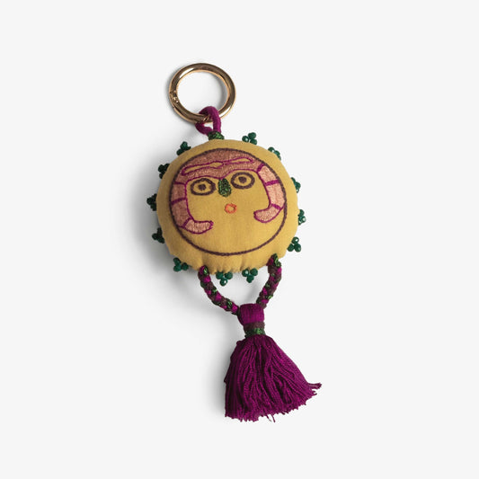 Mustard Sun Lady charm with embroidery and a braided tassel