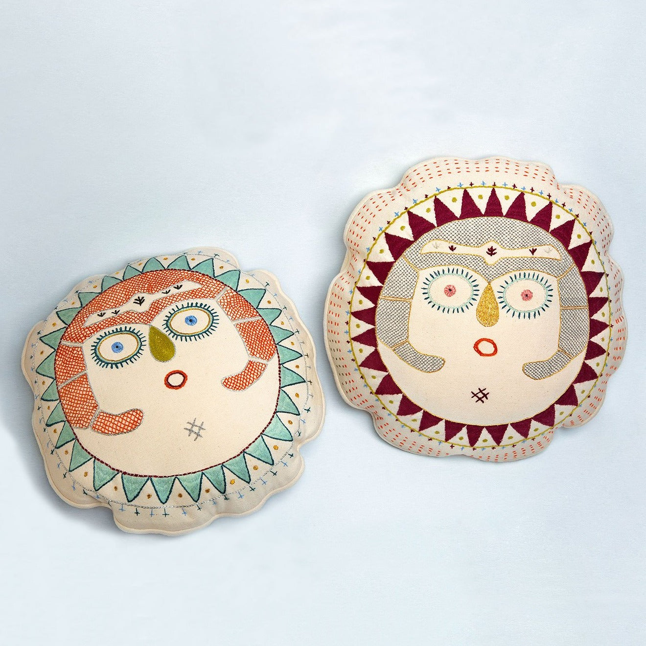 Coral and Beetroot Sun Lady round cushions next to each other