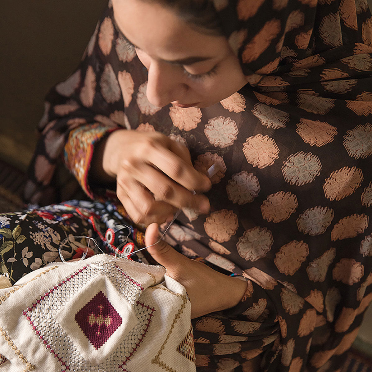 Baluchi woman embroidering Laneh Gouder Cushion