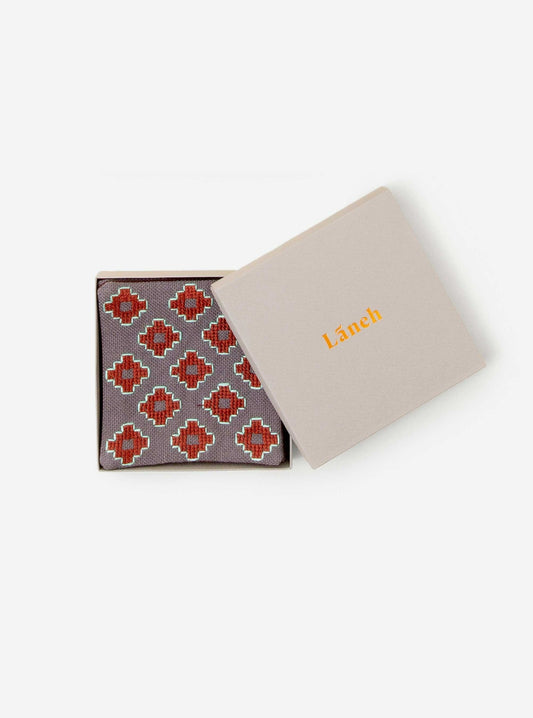 Dove grey Apadana coaster set with dark red flower embroidery inside a light grey Laneh box