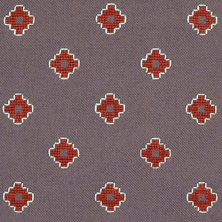 close up detail of dove grey Apadana placemat with dark red flower embroidery