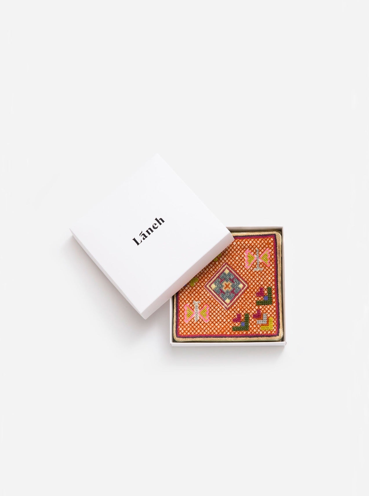 Tangerine orange Persian Garden coaster set with Baluchi embroidery inside a white Laneh box