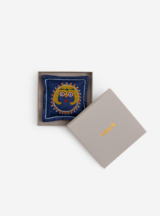 Navy Blue embroidered Sun Lady editioned Lavandin sachet with green beads placed inside a lavender Laneh box